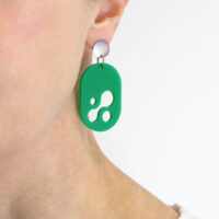 Droplet Earring in matte green acrylic being worn by dark haired woman.