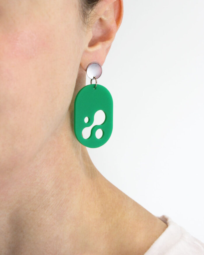 Droplet Earring in matte green acrylic being worn by dark haired woman.