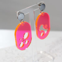 Translucent Pink Acrylic Earrings on display stand