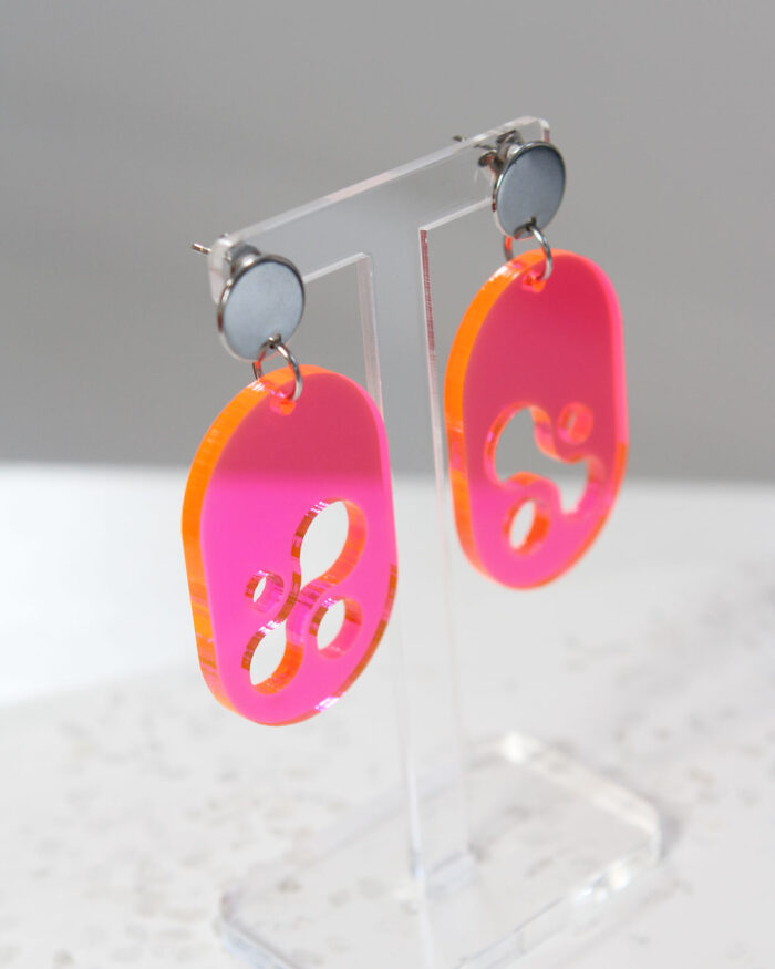 Translucent Pink Acrylic Earrings on display stand