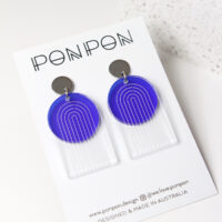 Pon Pon Through the Arch earrings in clear etched and frosted dark blue acrylic