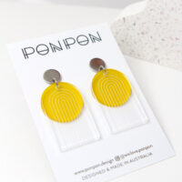 Pon Pon Through the Arch earrings in clear etched and frosted yellow acrylic