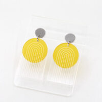 Pon Pon Through the Arch earrings in clear etched and frosted yellow acrylic