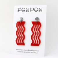 Pon Pon Acrylic Earrings in Transparent Red.